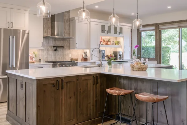 New custom home in Bozeman featuring timber details, large windows, and mountain-inspired architecture